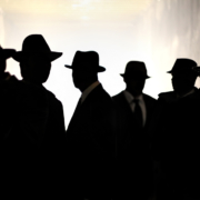 Silhouette of men in fedoras- covert spying